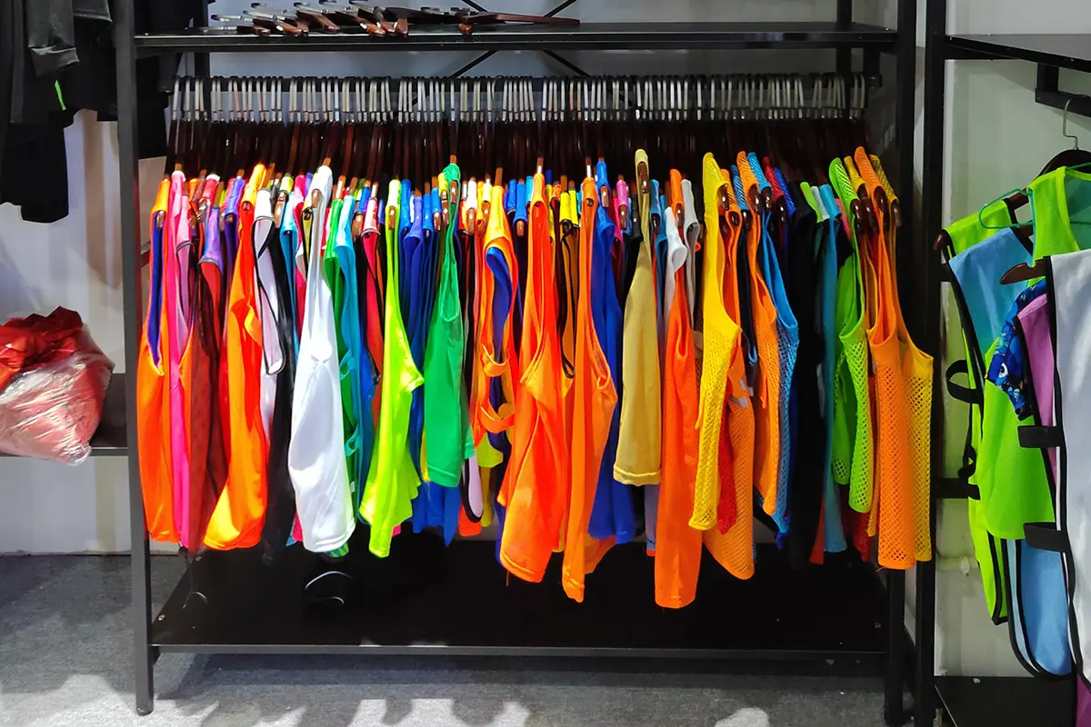Loose mesh jerseys hanging on a sample rack