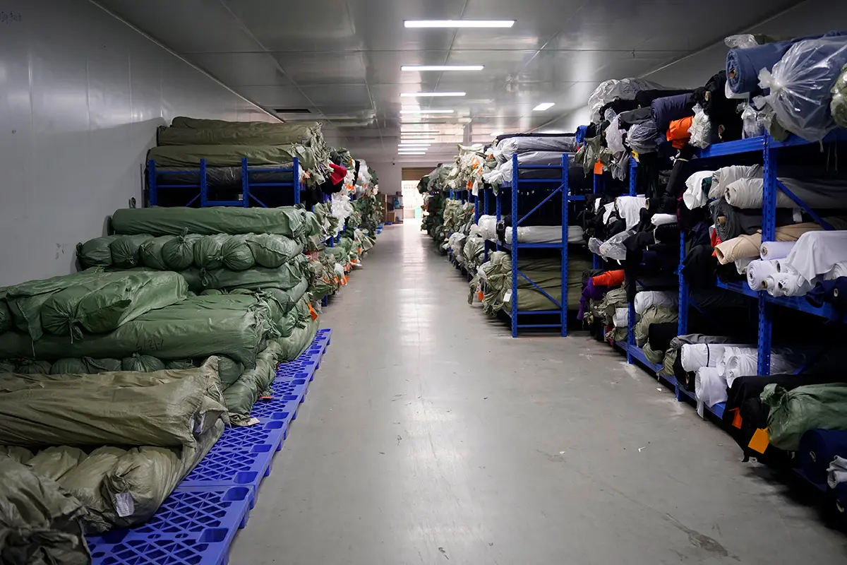 Fabric rolls organized along warehouse shelves