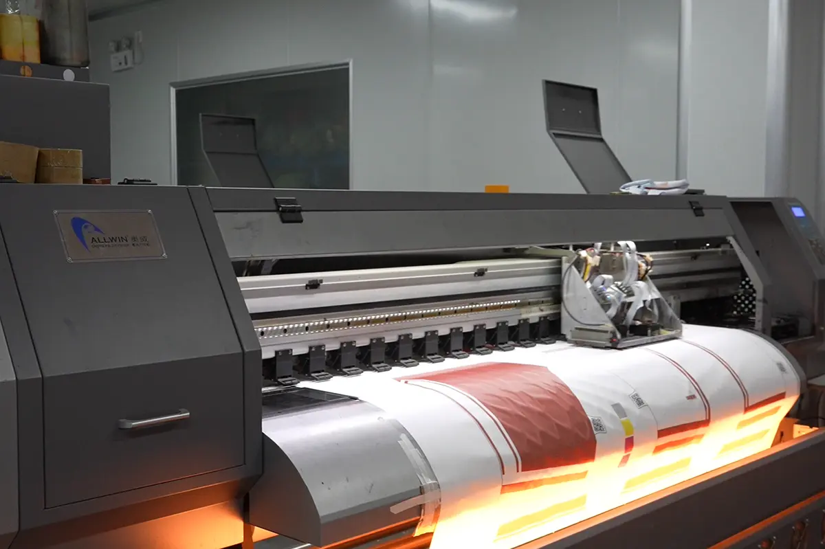 Wide-format printer producing red and white jersey panels